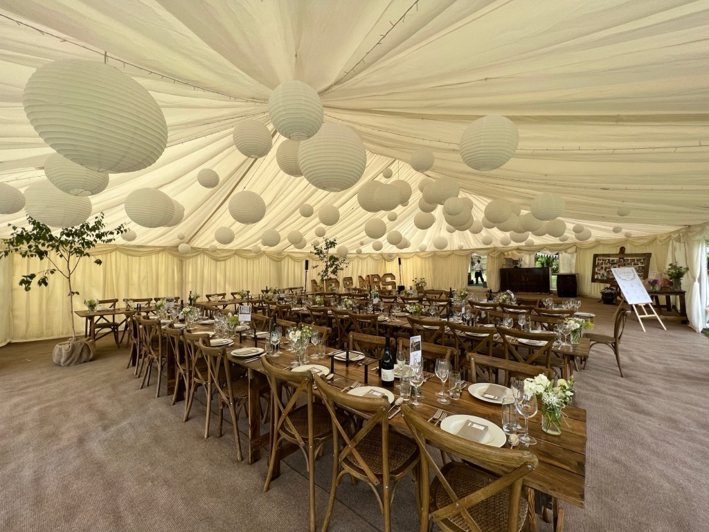 Wedding marquee hire with rustic tables